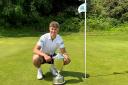 Ed Featherstone gets his hands on the historic Norfolk Amateur Championship trophy for the first time