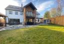 The garden of the property, with a patio and a purpose-built kitchen area