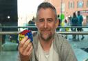 Astronomer Mark Thompson doing a 12-hour Rubik's Cube challenge to complete 100 puzzles for the DEC Ukraine appeal. Pictures: Brittany Woodman