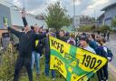 Norwich City fans celebrate the Canaries clinching the Championship title outside Carrow Road.