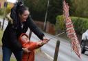 Three-year-old Cody Andrews battling with an umbrella with help from mum Leanna, as high winds hit Norfolk.