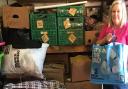 Tracey Cooper inside her Dussindale garage with the piles of donations