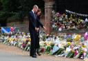 The Prince and Princess of Wales view flowers and tributes left at the Norwich gates at Sandringham in honour of the late Queen Elizabeth II