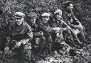 A team of Norfolk sugar-beet workers in the “good old days”  take a break for refreshments under the hedge and dubious skies