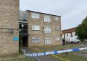 A police cordon outside a block of flats on Lefroy Road in Norwich where a man was found dead with a stab wound.