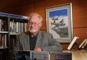 Aviation artist Mike Bailey at his beloved 2nd Air Division Memorial Library in Norwich in 2017. That picture behind him was painted by Mike for the late Bernard Matthews and was returned to the library following his death. Photo: Newsquest library