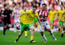 Norwich City's Kellen Fisher (left) and Stoke City's Million Manhoef battle for the ball