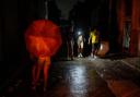 Residents walk down a street using a phone flashlight during a power outage following the failure of a major power plant in Havana (Ramon Espinosa/AP)