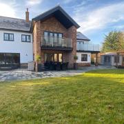 The garden of the property, with a patio and a purpose-built kitchen area