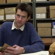 A proud moment: Dr Neil Faulkner with some of the artefacts discovered at the site of the Sedgeford archeological dig