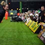 Lauren Hemp interacts with fans after the final whistle at Carrow Road