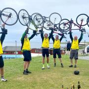 The 'Norfolk Fellaton' charity cycling team celebrates reaching John O'Groats in Scotland. From left: Mike Bartlett, Nick Gowing, Justin Morfoot, Ed Wharton, Ed Masters, Richard Hirst