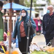 Shoppers around Norwich Market shopping local and staying safe in masks.