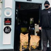 Jonathon Childs with some of the potatoes donated by Norfolk farmers to the Garden House pub in Norwich, to help feed people in need