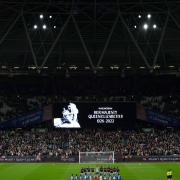 West Ham and FCSB players line up as the big screen displays a message in memoriam following the announcement of the death of Queen Elizabeth II, before the Europa Conference League match at the London Stadium