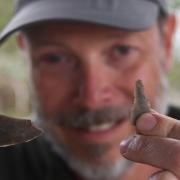 Project director, Andy Hutcheson, with two Neolithic flints worked as blades, found at the Arminghall Henge dig.