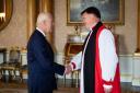 King Charles III holds an audience with Rt Rev Graham Usher, Bishop of Norwich, at Buckingham Palace, London, as he is appointed to be Lord High Almoner