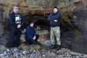 Amateur paleontologists, from left, Jonathan Stewart, John Clayden, and Dan Chamberlain, at the mammoth bones site at West Runton, where their finds have been taken from