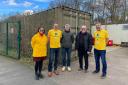 Aviva volunteers on site, with Graeme Hewitt (centre) of Whitlingham Country Park and Bill Russell (right of centre), the Equal Brewkery founder, in front of the charity's new shipping container