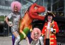 Pride town crier, Mike Wabe, launches Norwich Pride with a special cry and drag queens the Squirrels, MSK, left, and Miss Crystal, by the GoGoDino Prideosaurus at the Forum. Picture: DENISE BRADLEY