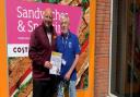 Jason Symonds, manager of the Queens Road Sainsburry's supermarket in Norwich, with Eddie and his guide dog Max