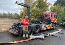 A Norfolk Fire and Rescue officer showcases Norfolk's longest hose