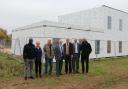 From left: James Onwuka, Jules Royle, Tony Emes, Cllr Martin Murrell, MP Jerome Mayhew, and Cllrs Fran Whymark and Ian Mackie stand behind the new medical centre in Rackheath