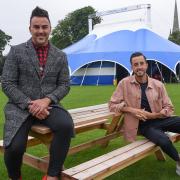 Stephen Crocker, chief executive and creative director of Norwich Theatre, and Paul Taylor-Mills, producer of The Wind in the Willows and artistic director of The Turbine Theatre, at the Interlude tent in Norwich Cathedral Close.