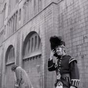 Michael Palin (right) with production staff at the filming of Monty Python's Queen's Own Kamikaze Highlanders sketch at Norwich Castle in 1971