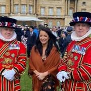 Kerri Parker (centre) with yeoman of the guard inside Buckingham Palace