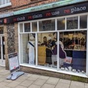 King Charles III and Queen Camilla in the window of the Salvation Army charity shop in Lower Gate Lane