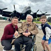 Ray Parke with the 'Just Jane' Lancaster Bomber at Lincolnshire Aviation Museum, with Jonny Cracknell, left, and his son Freddie