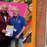 Jason Symonds, manager of the Queens Road Sainsburry's supermarket in Norwich, with Eddie and his guide dog Max