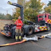 A Norfolk Fire and Rescue officer showcases Norfolk's longest hose