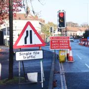 Overrunning work on Norfolk roads led to almost £500,000 in fines. Inset: County councillors Graham Plant and Mike Sands