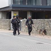 Armed police were seen walking along Geoffrey Watling Way next to Carrow Road this morning