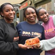 Tola Durowoju has opened Buka Street in Norwich Market. Pictured: Tola, centre, and her daughters, Zarah, left, and Amanah