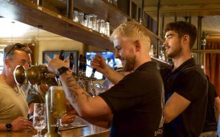 Pints being poured in the main bar area at The Suffield Arms